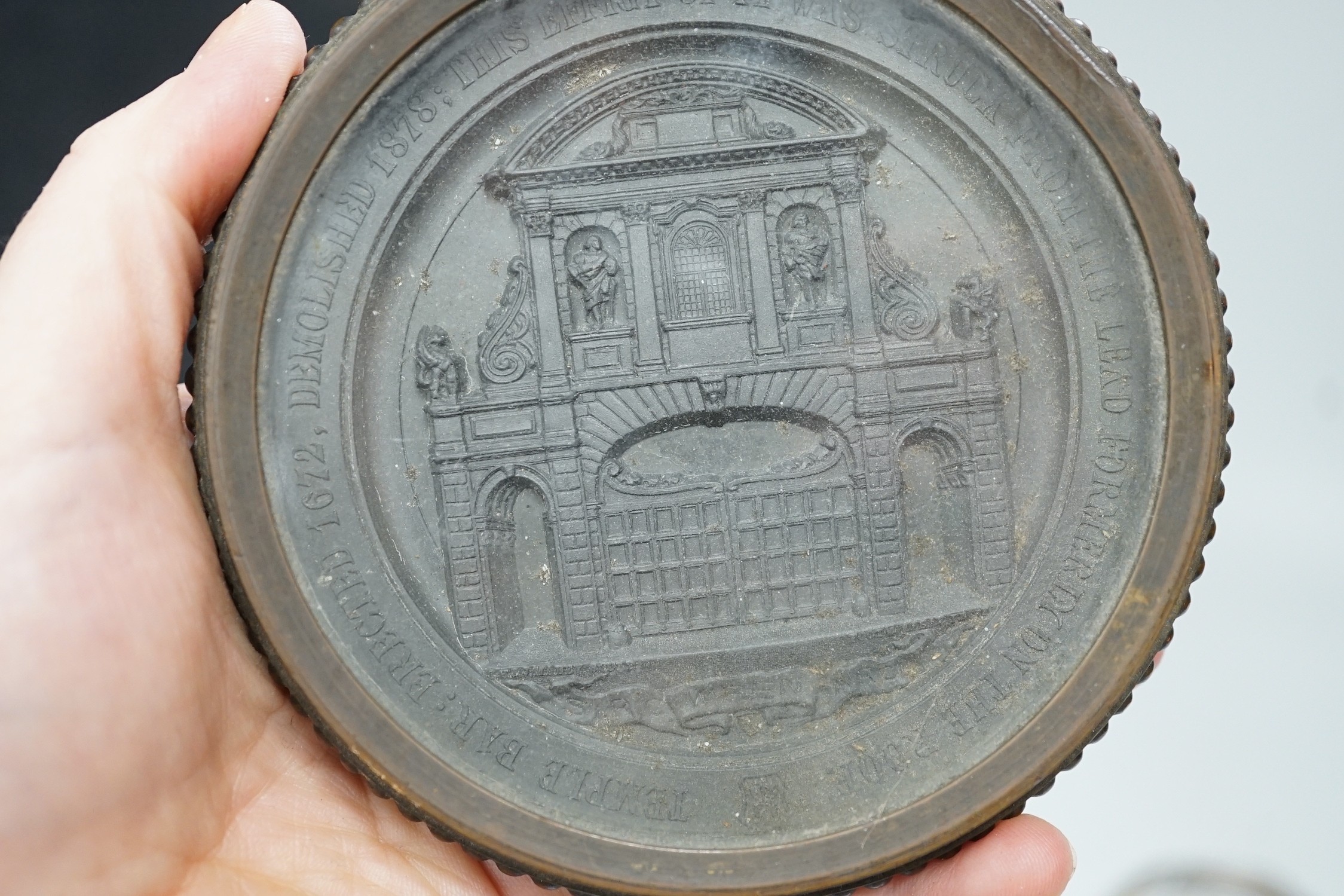 Temple Bar commemorative cast lead and brass paperweight, ‘Temple Bar: erected 1672, demolished 1878; this effigy of it was struck from the lead formally on the roof’ and a 19th century gilt metal relief glass cased pape